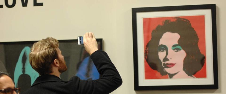 Visitors attend the biggest in Canada exhibition of works of pop art legend Andy Warhol in Yaletown warehouse in Vancouver, Canada, Feb.27, 2015.