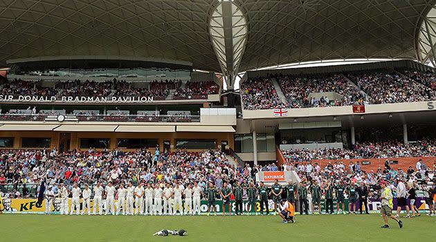 Cricketers and spectators at Adelaide Oval for day two of the second Ashes test mark a minute's silence for Nelson Mandela. Photo: Getty.