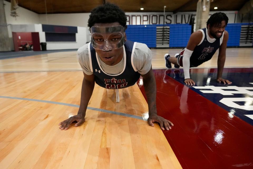 Davin Francis and Ansley Almonor do push-ups during practice at Fairleigh Dickinson University, in Teaneck, Thursday, October 19, 2023