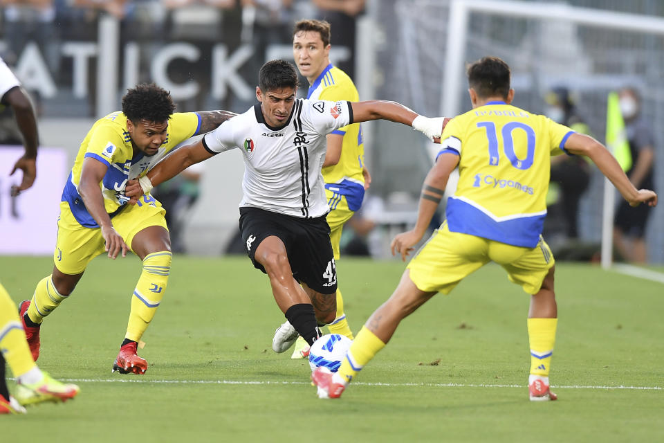 Spezia's Dīmītrīs Nikolaou tries to dribble between Juventus' Weston McKennie, left, and Paulo Dybala during the Italian Serie A soccer match between Spezia and Juventus, at the Alberto Picco stadium in La Spezia, Italy, Wednesday, Sept. 22, 2021. (Tano Pecoraro/LaPresse via AP)