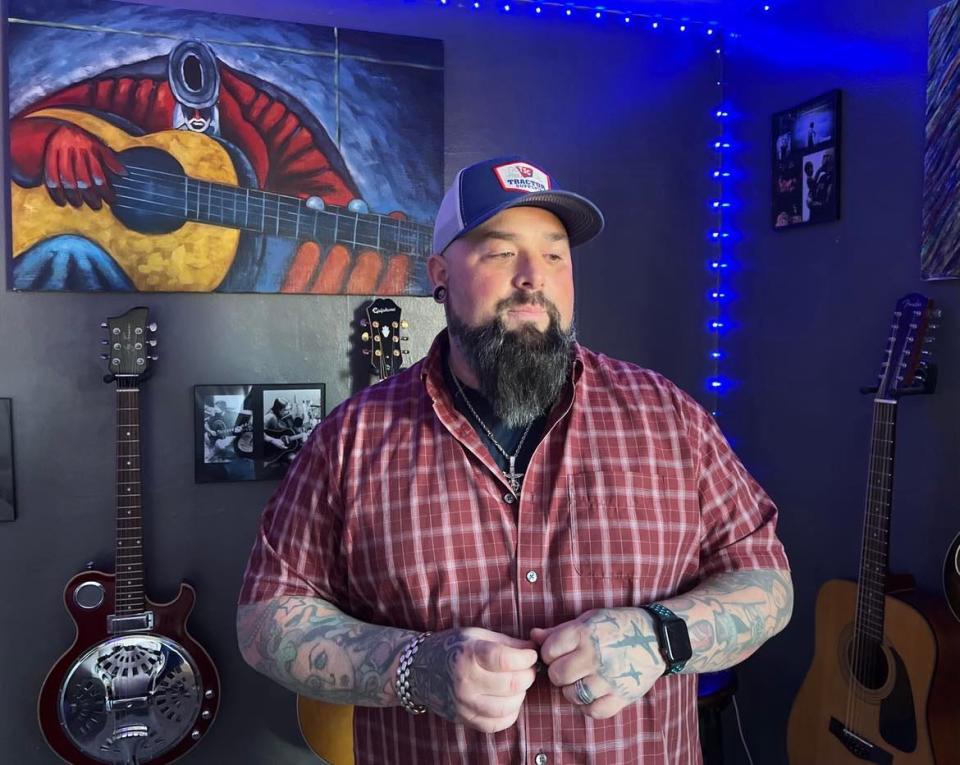 Aaron Hymes, a Christian country music artist, is shown at his Stark County home, where he rehearses and records music with his band.