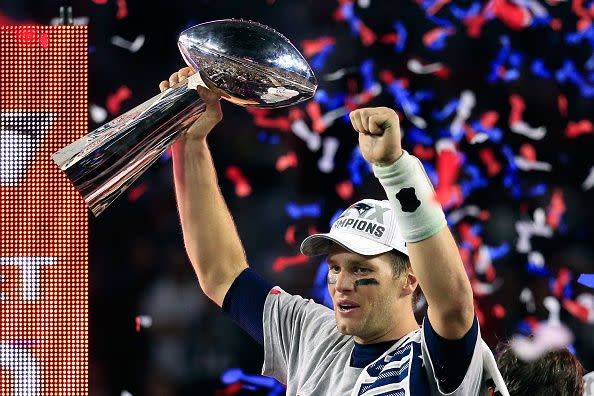 2015:  Tom Brady #12 of the New England Patriots celebrates with the Vince Lombardi Trophy after defeating the Seattle Seahawks during Super Bowl XLIX at University of Phoenix Stadium on February 1, 2015 in Glendale, Arizona. The Patriots defeated the Seahawks 28-24.  (Photo by Rob Carr/Getty Images)