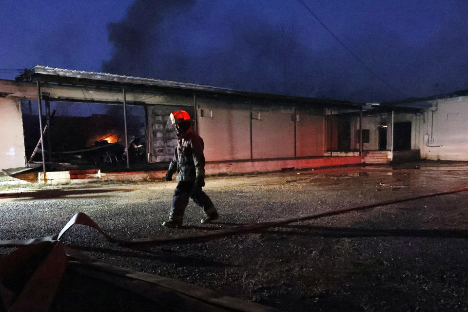 A Selma firefighter walks back the truck after putting out a fire that started from a tornado that passed through downtown Selma, Ala., Thursday, Jan. 12, 2023. (AP Photo/Butch Dill)