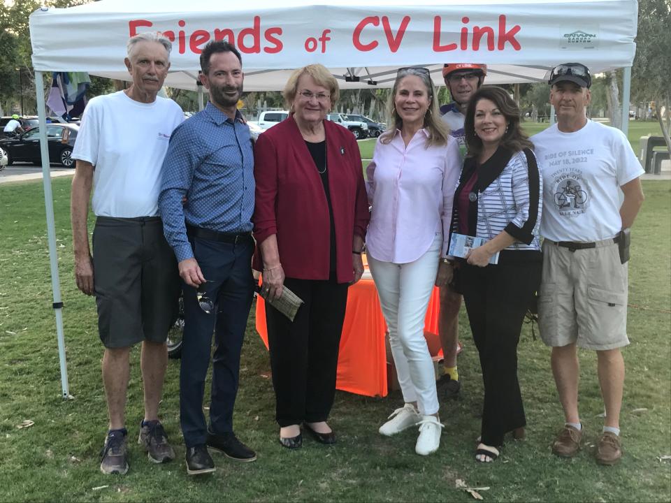 From left, Jim Rothblatt, Tom Kirk, Lisa Middleton, Jan Harnik, Gary Lueders, Linda Evans and John Siegel pose for a picture at the Ride of Silence event at Ruth Hardy Park in Palm Springs, Calif., on May 18, 2022.