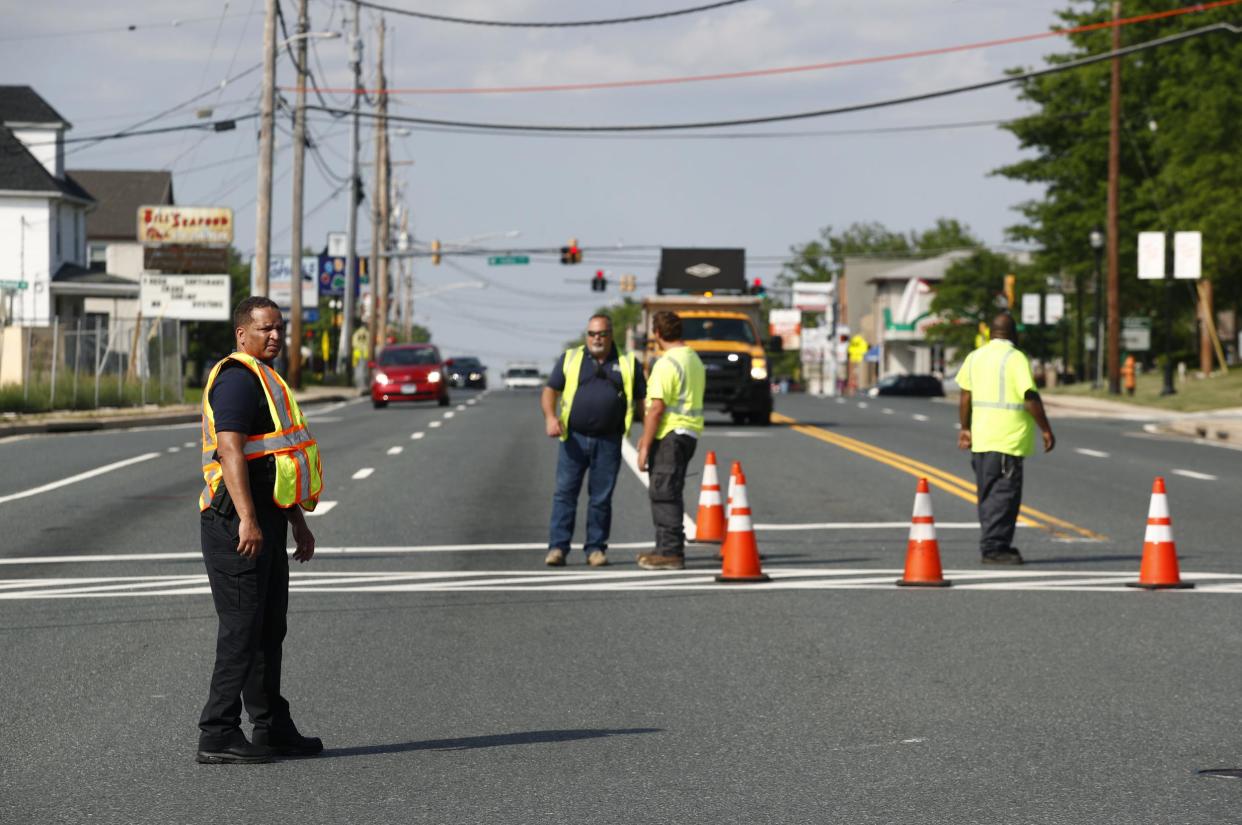 Officials guard a roadblock near a scene where a Baltimore County police officer died while investigating a suspicious vehicle: AP Photo/Patrick Semansky