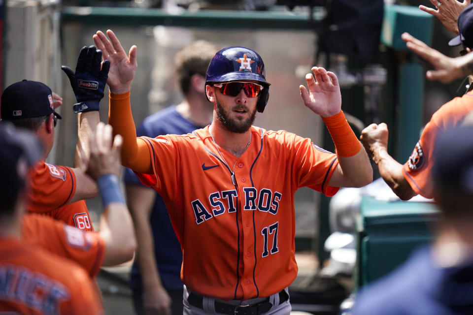 Houston Astros' David Hensley is congratulated by teammates after he scored on a double by Jose Altuve during the second inning of a baseball game against the Los Angeles Angels, Sunday, Sept. 4, 2022, in Anaheim, Calif. (AP Photo/Jae C. Hong)
