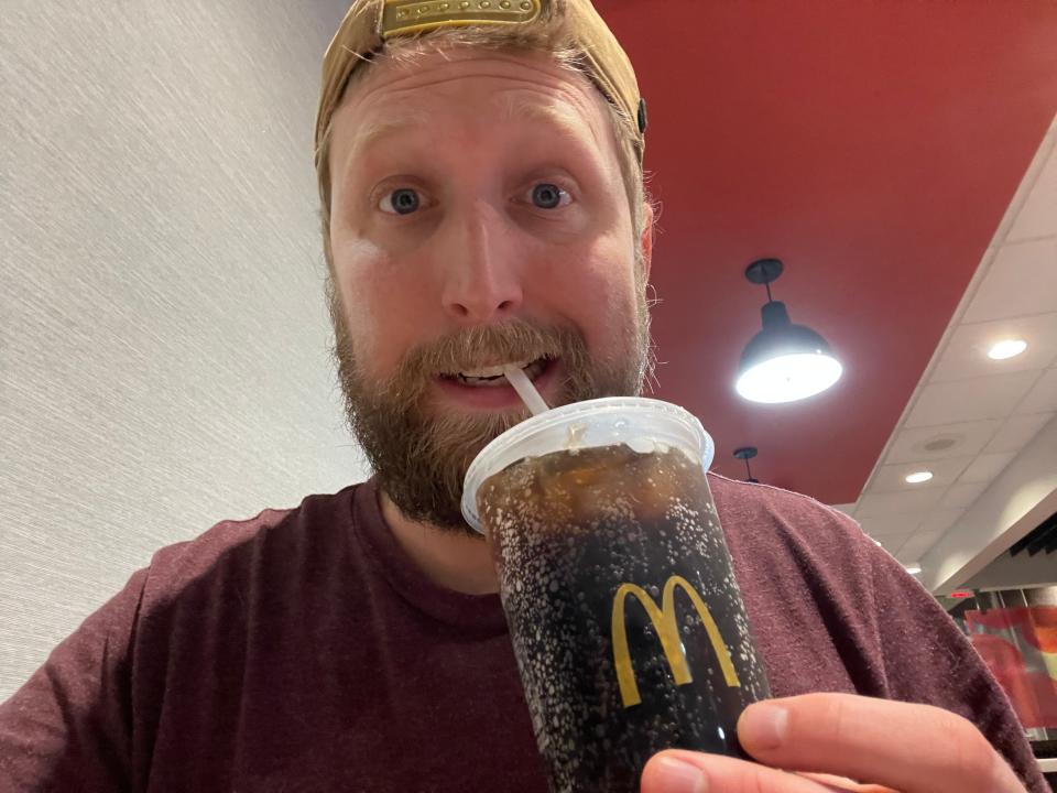 tim sipping on a diet coke from Mcdonalds at mcdonalds