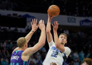 Orlando Magic forward Franz Wagner (22) passes over Charlotte Hornets center Mason Plumlee (24) during the first half of an NBA basketball game on Friday, Jan. 14, 2022, in Charlotte, N.C. (AP Photo/Rusty Jones)