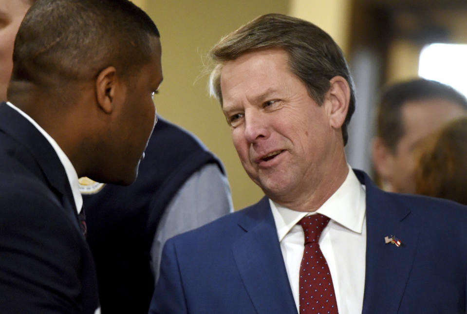 Georgia Governor-elect Brian Kemp, right, talks to Richmond County (Ga.) Marshal Ramone Lamkin during a stop in Augusta, Ga., as part of what he calls his "thank-you tour" Wednesday Jan/ 9, 2019. Kemp says he plans to focus his first year in office on helping small businesses, cutting taxes and cracking down on violent gangs. (Michael Holahan/The Augusta Chronicle via AP)