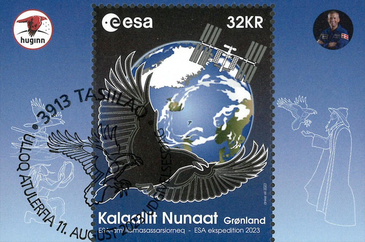  postage stamp showing earth, the international space station and a raven 