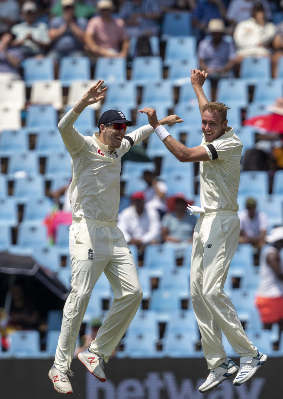 England's bowler Stuart Broad, right, celebrates with teammate Craig Overton after dismissing South Africa's captain Faf du Plessis for 29 runs on day one of the first cricket test match between South Africa and England at Centurion Park, Pretoria, South Africa, Thursday, Dec. 26, 2019. (AP Photo/Themba Hadebe)