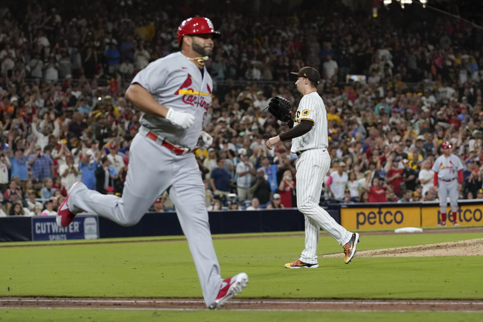 San Diego Padres starting pitcher Blake Snell, right, looks to the catcher after giving up his first hit of the night, a single to St. Louis Cardinals' Albert Pujols, left, during the seventh inning of a baseball game Wednesday, Sept. 21, 2022, in San Diego. (AP Photo/Gregory Bull)