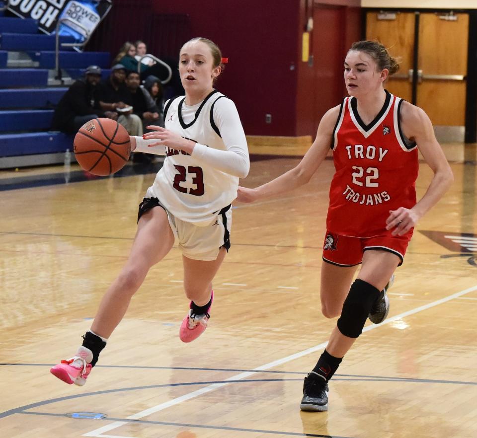 Elmira's Ellie Clearwater (23) drives to the basket as Troy's Alyssa Parks (22) defends during the Express' 43-38 win in a Girls Division consolation game at the Josh Palmer Fund Clarion Classic on Dec. 29, 2023 at Elmira's Ernie Davis Academy.
