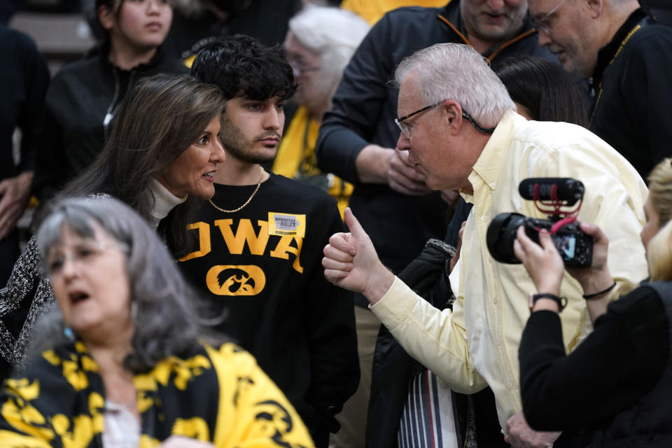 Republican presidential candidate Nikki Haley greets a fan before an NCAA college basketball game between Iowa and Minnesota, Saturday, Dec. 30, 2023, in Iowa City, Iowa. (AP Photo/Charlie Neibergall)