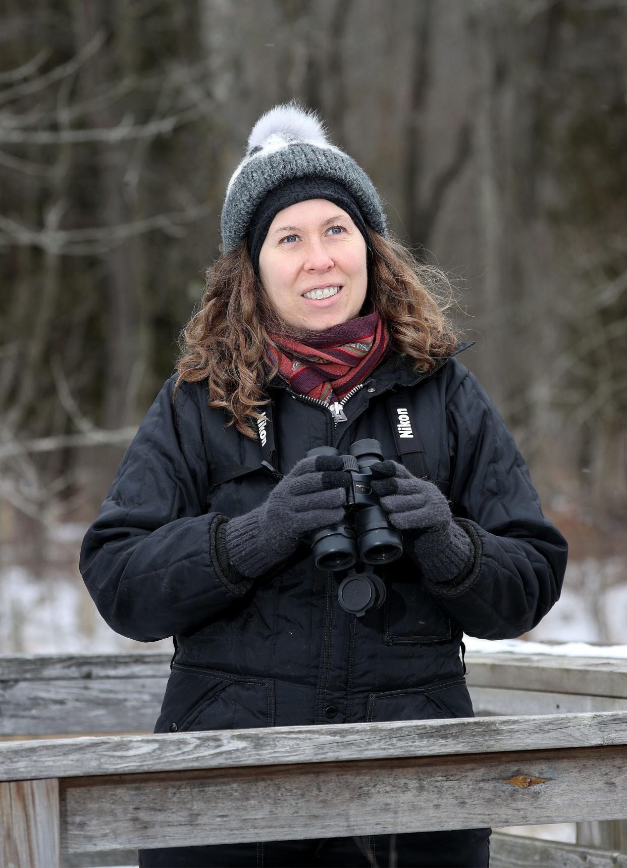 Rebecca Jabs, a Manitowoc artist/graphic designer who collaborated with author/naturalist John Bates on a guidebook called "Wisconsin's Wild Lakes," looks for birds along the Woodland Dunes area, Monday, January 17, 2022, in Manitowoc, Wis.