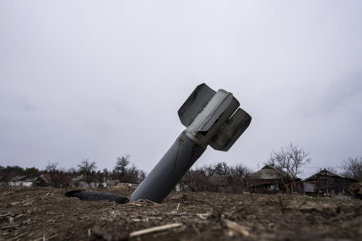 The tail of a missile sticks out in a residential area in Yahidne, near of Dnipro, Ukraine, Tuesday, April 12, 2022. (AP Photo/Evgeniy Maloletka)