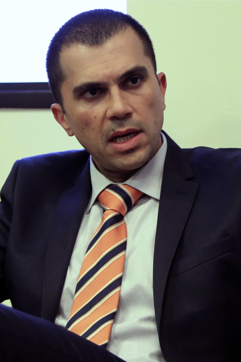 Cyprus' deputy minister of tourism Savvas Perdios speaks with the Associated Press during an interview at his office in Nicosia, Cyprus, Wednesday, Nov. 13, 2019. Perdios says his organization is teaming up with Israeli authorities to jointly promote the east Mediterranean as prime cruise line holiday destination. (AP Photo/Petros Karadjias)