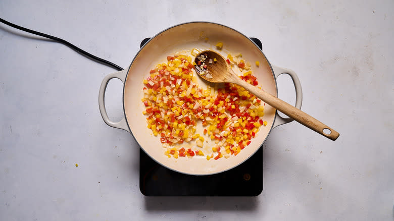 diced pepper and onion cooking in pot