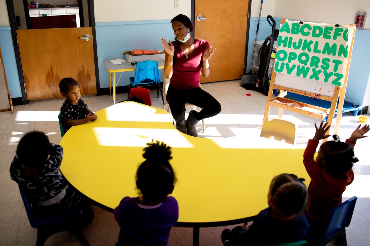 Rachel Smith, a daycare teacher, leads a song with eighteen-month to two-year-olds on Wednesday, Jan. 26, 2022, at Nanny's Multi Level Learning Center in the Cincinnati neighborhood of Avondale. The child care industry has been dealing with staff shortages due to the COVID-19 pandemic.