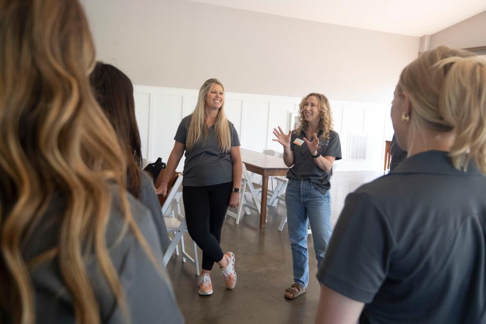 Stefanie Benjamin, right, an associate professor at University of Tennessee's Department of Retail, Hospitality and Tourism Management, and Nancy Barger, an industry expert, meet with students planning a wedding as part of their studies.