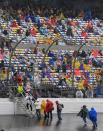 Fans make their way to the grandstands during a rain delay before the NASCAR Daytona 500 auto race at Daytona International Speedway in Daytona Beach, Fla., Sunday, Feb. 26, 2012. (AP Photo/John Raoux)