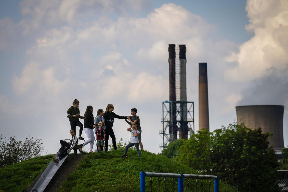 SCUNTHORPE, ENGLAND - MAY 22: Children play in park against the backdrop of British Steel's Scunthorpe works which has been forced into liquidation today on May 22, 2019 in Scunthorpe, England. The High Court in London has ordered British Steel Limited into compulsory liquidation. (Photo by Christopher Furlong/Getty Images)