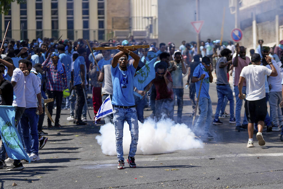 Eritrean protesters clash with Israeli riot police in Tel Aviv, Israel, Saturday, Sept. 2, 2023. Hundreds of Eritrean asylum seekers smashed shop windows and police cars in Tel Aviv on Saturday and clashed with police during a protest against an event organized by the Eritrea Embassy. The Israeli police said 27 officers were injured in the clashes, and at least three protesters were shot when police opened fire with live rounds when they felt "real danger to their lives." (AP Photo/Ohad Zwigenberg)