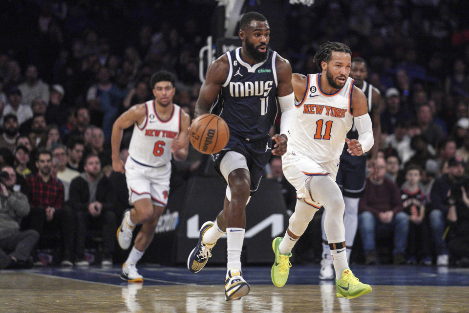 Dallas Mavericks forward Tim Hardaway Jr., dribbles up court away from New York Knicks guard Jalen Brunson (11) during the first quarter of an NBA basketball game, Saturday, Dec. 3, 2022, in New York. (AP Photo/Bebeto Matthews)