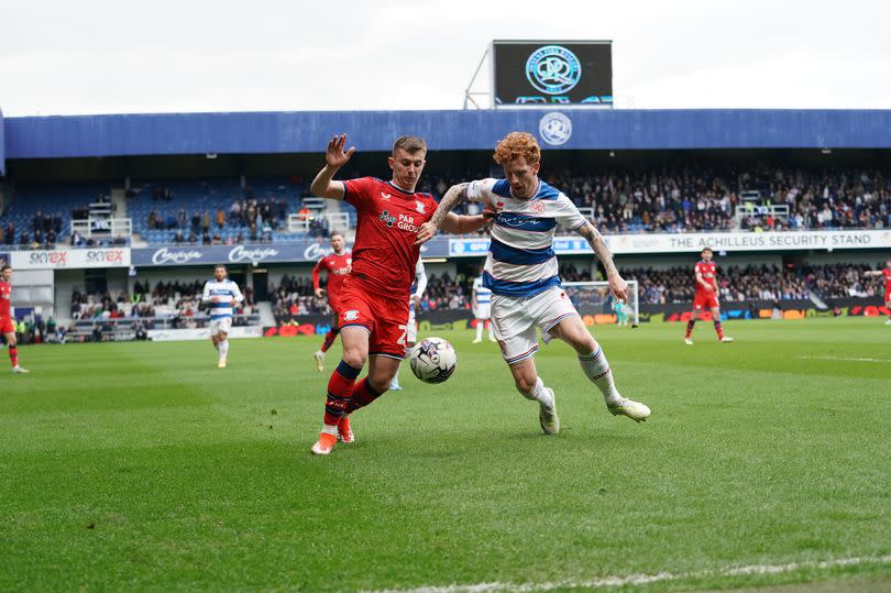 Preston North End's Ben Woodburn under pressure from Queens Park Rangers' Jack Colback during the Sky Bet Championship match between Queens Park Rangers and Preston North End at Loftus Road on April 20, 2024 in London, England.