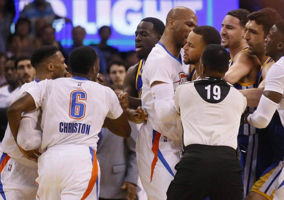 From left, Oklahoma City Thunder guard Russell Westbrook and guard Semaj Christon (6), Golden State Warriors forward Draymond Green, Thunder forward Taj Gibson, and Warriors guards Stephen Curry and Klay Thompson get into a tussle during the second quarter of an NBA basketball game in Oklahoma City, Monday, March 20, 2017. At right are Warriors center Zaza Pachulia and Thunder guard Victor Oladipo. (AP Photo/Sue Ogrocki)