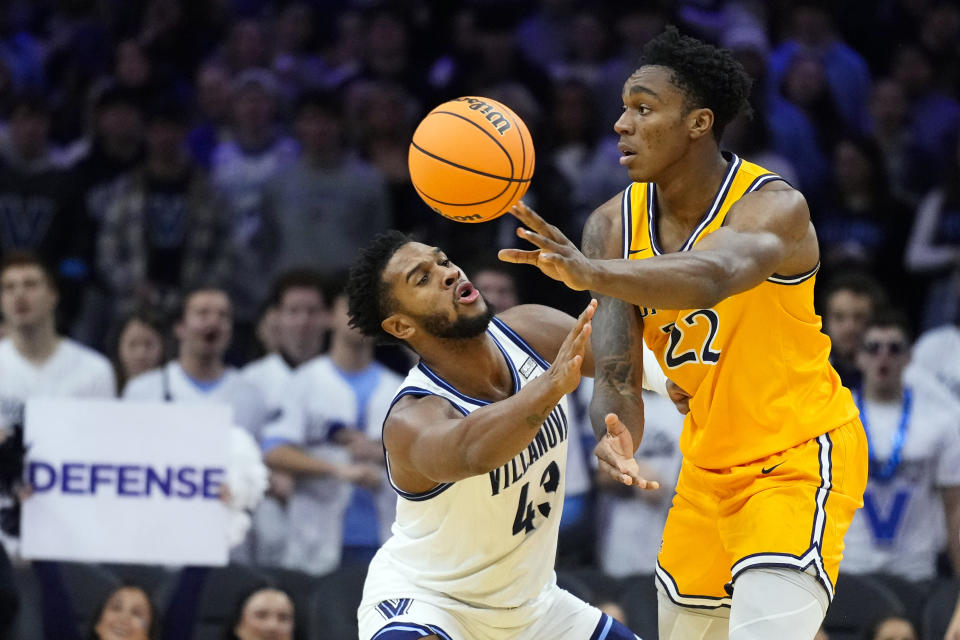 Drexel's Amari Williams, right, passes the ball past Villanova's Eric Dixon during the half of an NCAA college basketball game, Saturday, Dec. 2, 2023, in Philadelphia. (AP Photo/Matt Rourke)