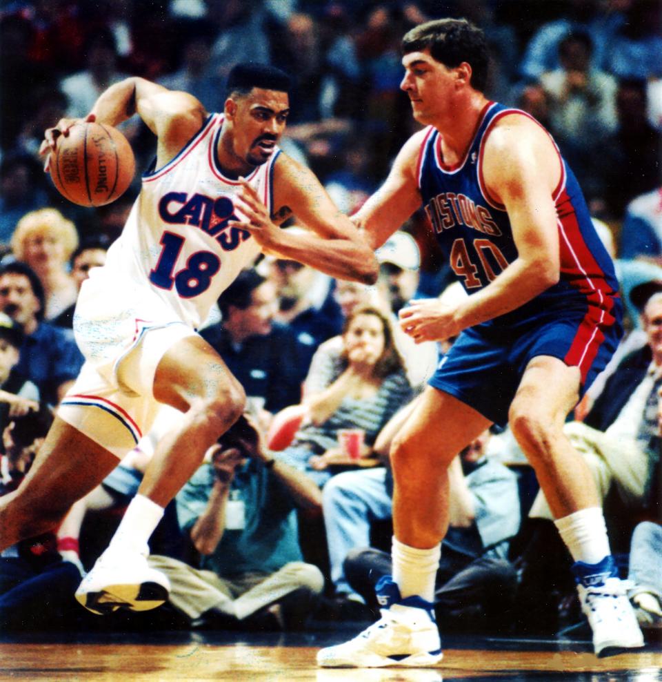 Cleveland Cavaliers forward John "Hot Rod" Williams, left, drives to the basket against the Detroit Pistons' Bill Laimbeer at the Richfield Coliseum on Oct. 2, 1993, in Richfield, Ohio.