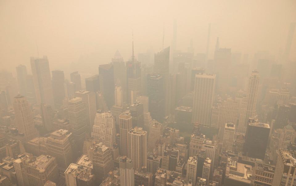 New York City is covered in haze as photographed from the Empire State Building observatory - AP