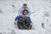 <p>Bridget Mitchell, rear, sleds down the Water Tower hill in Chestnut Hill with her daughter, Olivia Mitchell, 9, in Philadelphia on March 7, 2018. (Photo: Michael Bryant/The Philadelphia Inquirer via AP) </p>