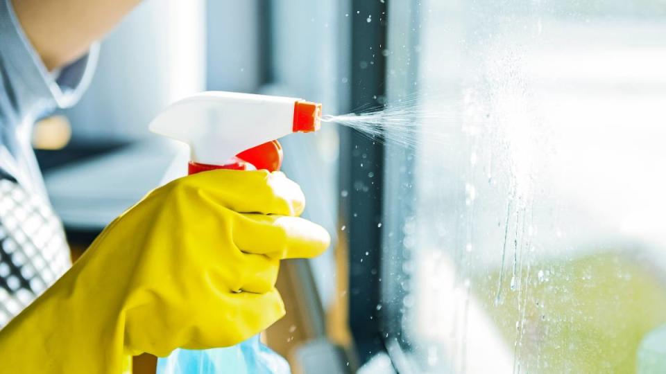 Uses for coffee filters: Young woman washing window