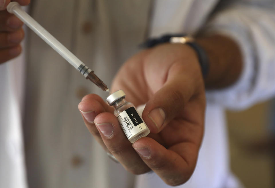 A doctor fills a syringe with the Johnson & Johnson COVID-19 vaccine at a vaccination center in Kabul, Afghanistan, Sunday, July 11, 2021. The COVID-19 vaccines were donated by the United States and delivered through the U.N.-backed COVAX program. Another shipment is expected to arrive later this month. (AP Photo/Rahmat Gul)