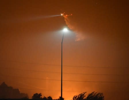 Firefighters battle a wind-driven wildfire in Sylmar, California