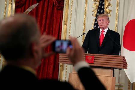 An attendee takes a picture of U.S. President Donald Trump during a joint news conference with Japan's Prime Minister Shinzo Abe (not pictured), at Akasaka Palace in Tokyo, Japan May 27, 2019. REUTERS/Jonathan Ernst