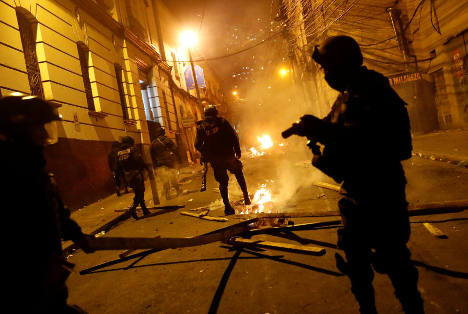 A police officer stamps on a fire during clashes between protesters against Bolivia's President Evo Morales and government supporters, in La Paz, Bolivia Nov. 7, 2019. (Photo: Kai Pfaffenbach/Reuters)