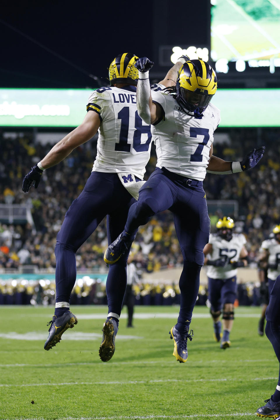 Michigan tight end Colston Loveland, left, and running back Donovan Edwards (7) celebrate after Loveland's touchdown during the first half of an NCAA college football game against Michigan State, Saturday, Oct. 21, 2023, in East Lansing, Mich. (AP Photo/Al Goldis)