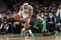 Charlotte Hornets' P.J. Washington takes a loose ball away from Boston Celtics' Dennis Schroder during the second half of an NBA basketball game Wednesday, Jan. 19, 2022, in Boston. (AP Photo/Winslow Townson)