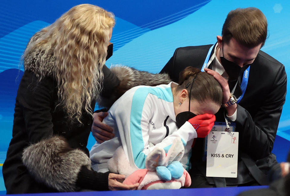 Russia's Kamila Valieva reacts with coaches Eteri Tutberidze and Daniil Gleikhengauz after missing the medals at the Olympic women's figure skating