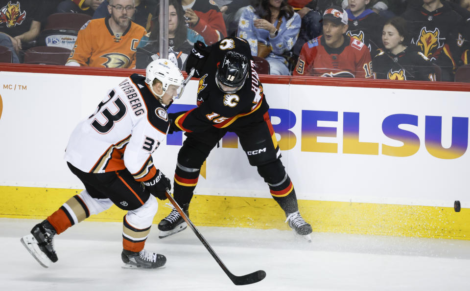 Anaheim Ducks forward Jakob Silfverberg (33) steals the puck from Calgary Flames forward Dryden Hunt (15) during the third period of an NHL hockey game Tuesday, April 2, 2024, in Calgary, Alberta. (Jeff McIntosh/The Canadian Press via AP)