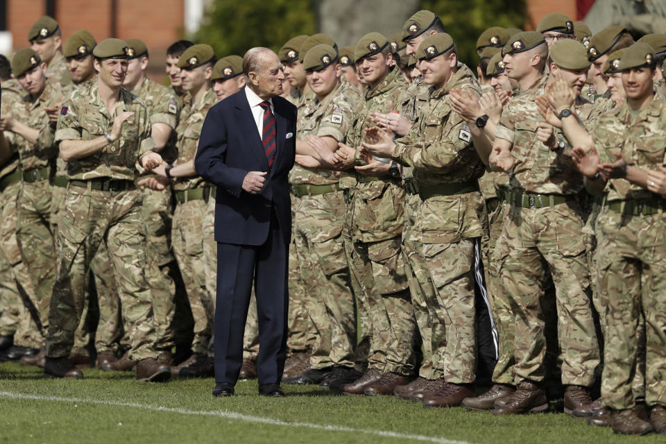 FILE - In this Thursday, March 30, 2017 file photo, Britain's Prince Philip, in his capacity of Colonel, Grenadier Guards, talks with members of the 1st Battalion Grenadier Guards as they applaud the final whistle from the sidelines, of the Manchester Cup inter-company football match at Lille Barracks in Aldershot, England. Buckingham Palace officials say Prince Philip, the husband of Queen Elizabeth II, has died, it was announced on Friday, April 9, 2021. He was 99. Philip spent a month in hospital earlier this year before being released on March 16 to return to Windsor Castle. Philip, also known as the Duke of Edinburgh, married Elizabeth in 1947 and was the longest-serving consort in British history. (AP Photo/Matt Dunham, Pool, File)