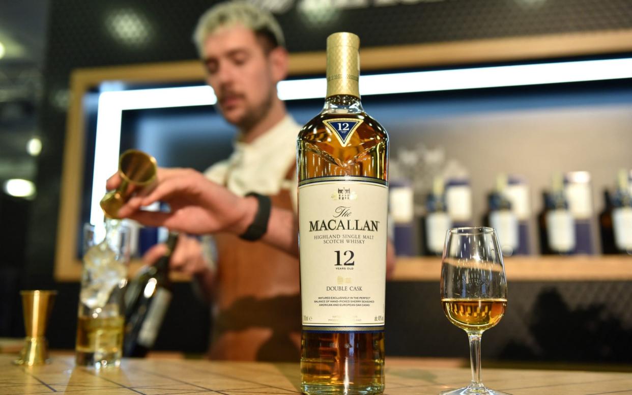 A bar tender pours 12 years old Macallan highland single malt scotch whisky - John Keeble/Getty Images Europe 