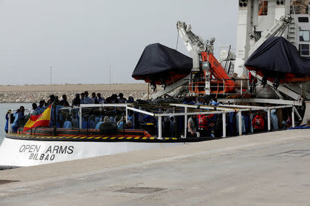 FILE PHOTO: Migrants wait to disembark from Spanish NGO Proactiva Open Arms in the Sicilian harbour of Pozzallo, Italy, March 17, 2018. Picture taken March 17, 2018. REUTERS/Antonio Parrinello/File Photo