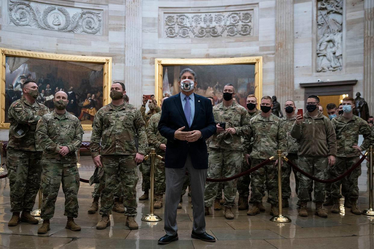 Sen. Joe Manchin gives National Guard members a tour of the U.S. Capitol Rotunda on Jan. 22, 2021 in Washington, DC.