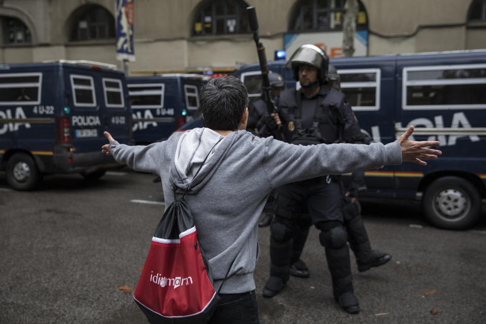 <p>Pro-Referendum supporters clash with members of the Spanish National Police, after police tried to enter a polling station to retreive ballot boxes during today’s referendum vote on Oct. 1, 2017 in Barcelona, Spain. (Photo: Dan Kitwood/Getty Images) </p>