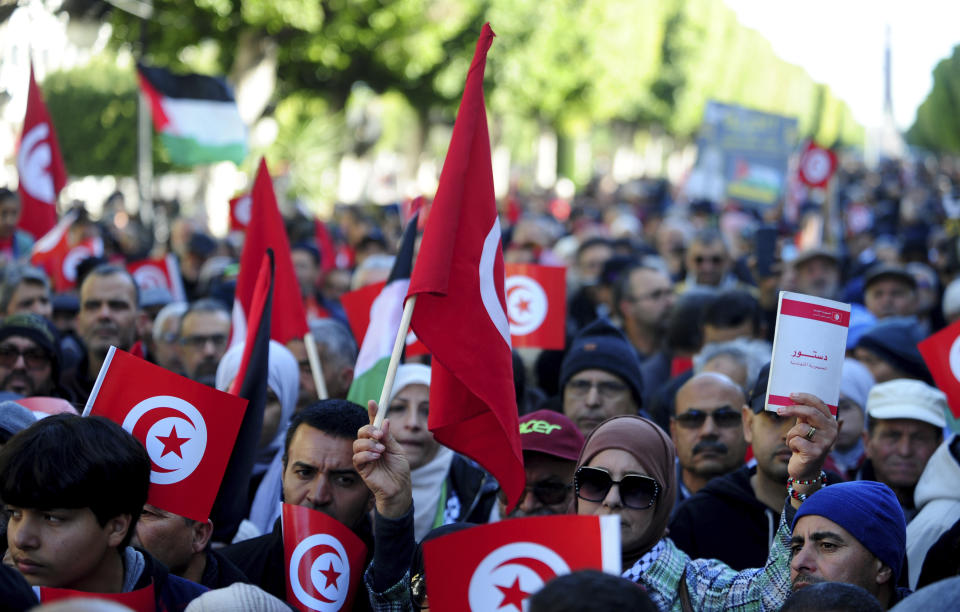 People commemorate the 13th anniversary of the Tunisian uprising in Avenue Habib Bourguiba, Tunis, Sunday, Jan. 14, 2024. (AP Photo/Hassene Dridi)