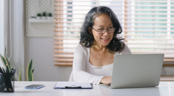 A 62-year-old woman smiles after officially filing for Social Security benefits.